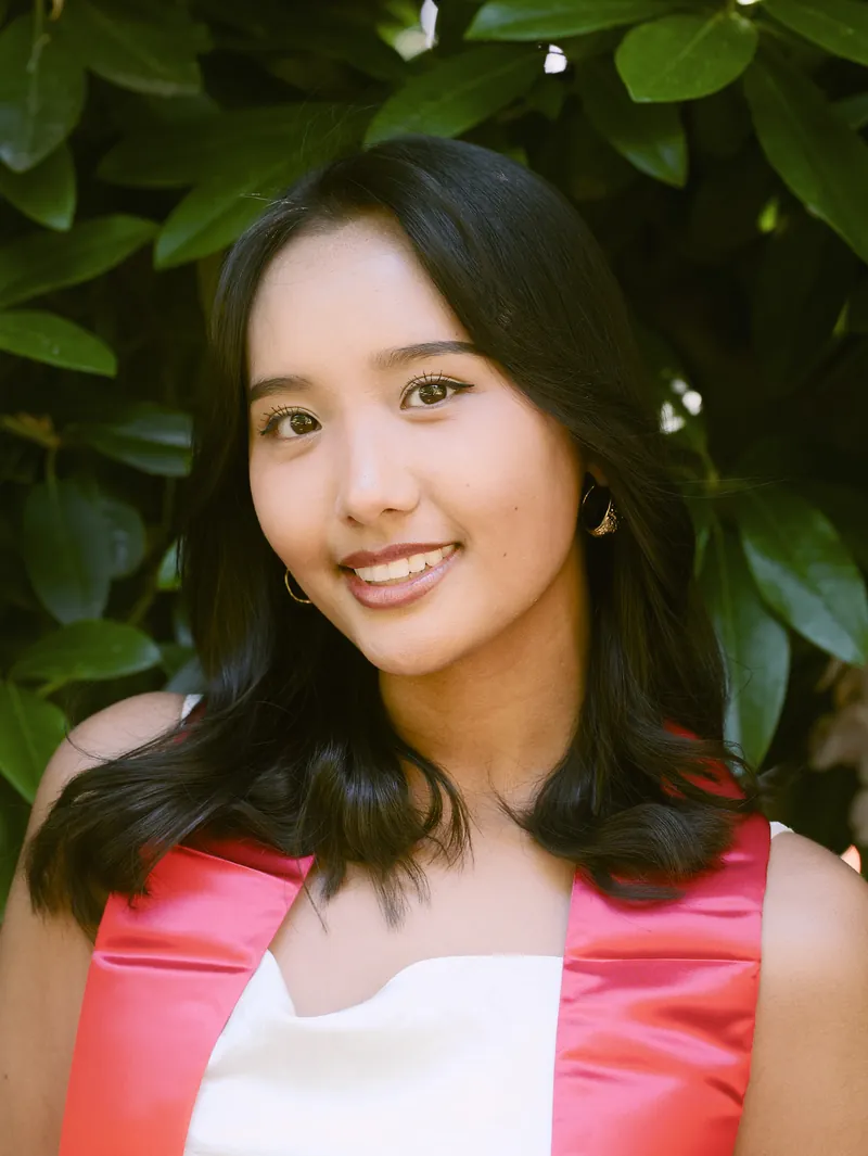 Seattle University graduate close up smile with green bokeh