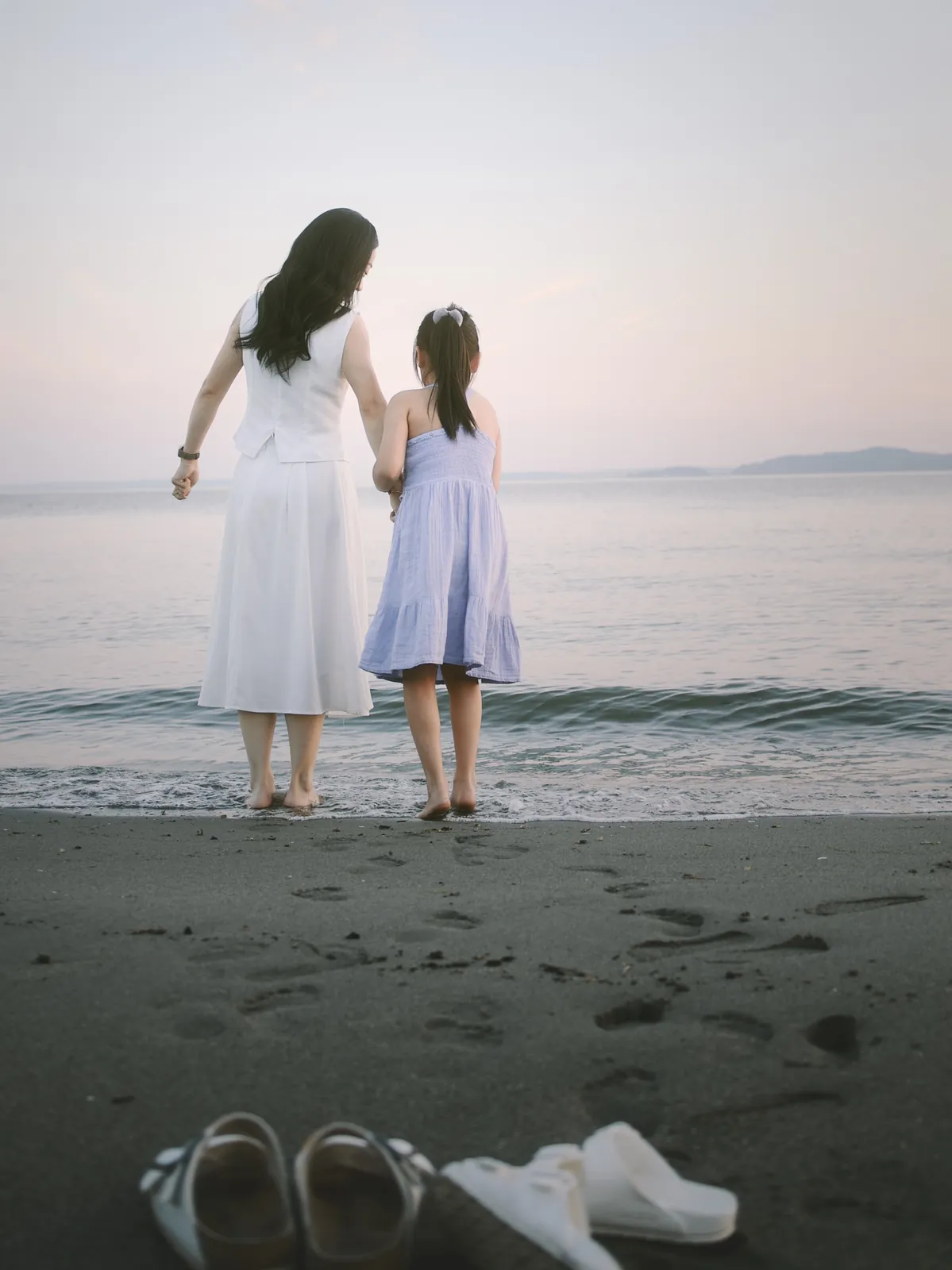 Mother and daughter at Discovery Park beach in soft airy sunset, Seattle family lifestyle photo