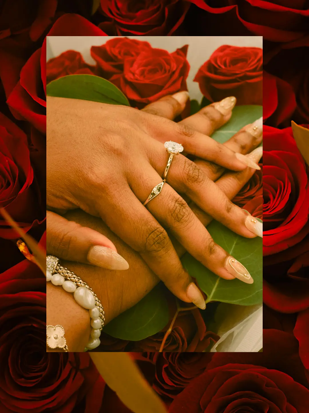 Close-up of engagement rings against red roses