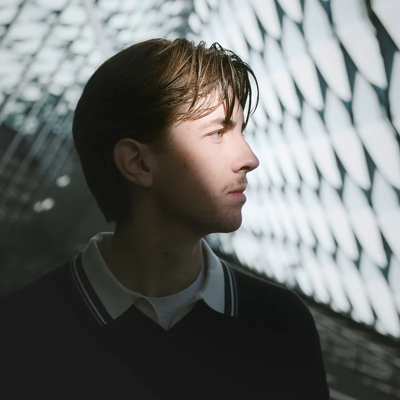 Senior in profile in dramatic lattice shadows in Seattle