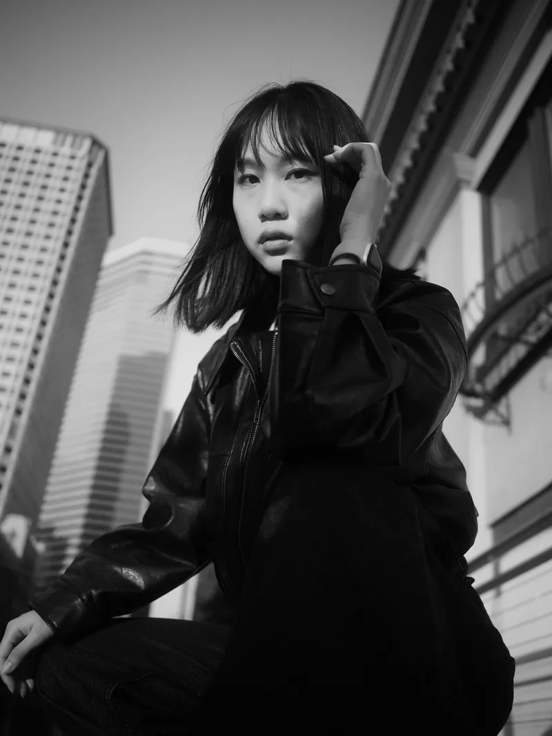Seattle high school senior portrait in leather jacket with downtown skyline perspective