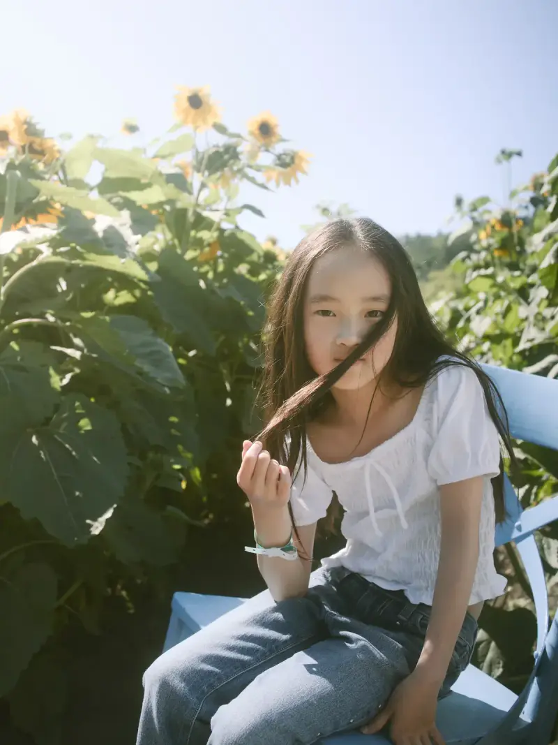 Senior portrait among golden summer sunflowers in Seattle