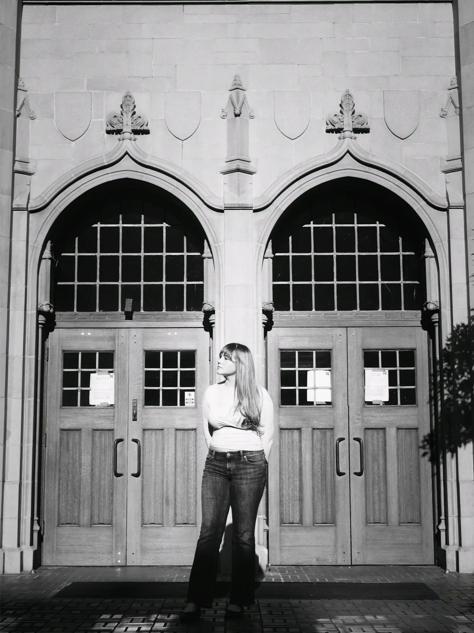 Senior portrait in front of a Gothic campus entrance