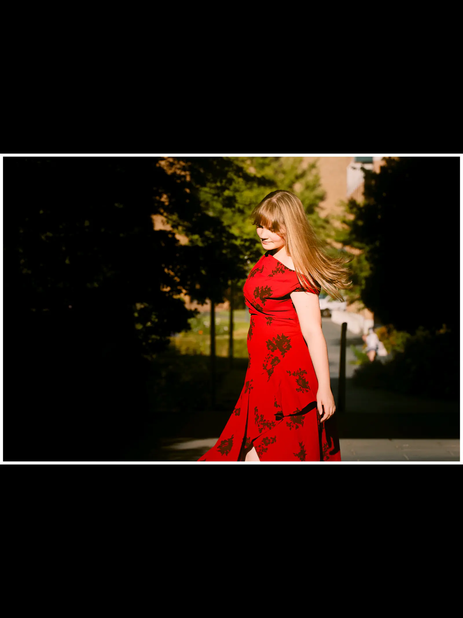 Senior in a red dress framed by greenery in a portrait diptych