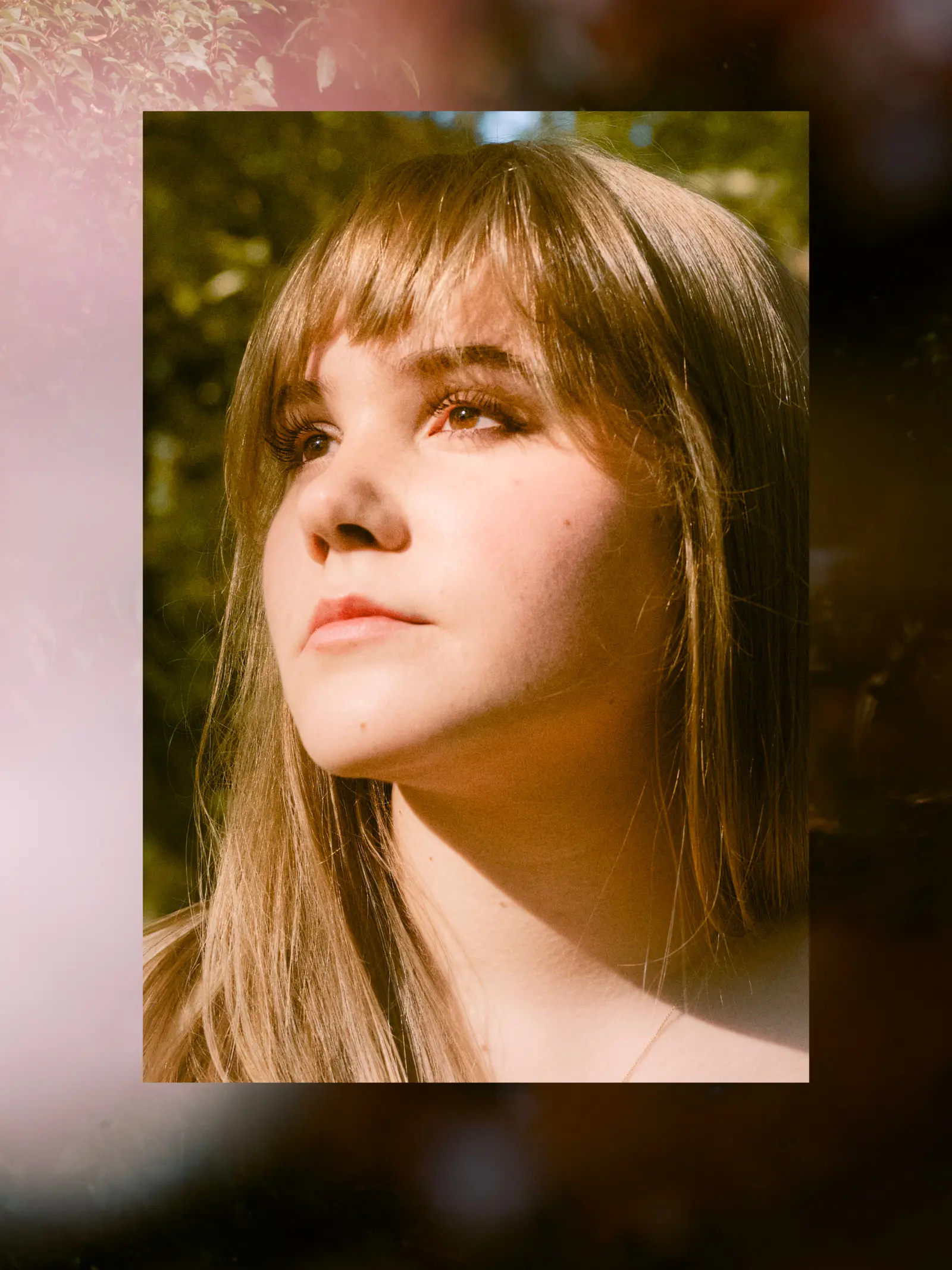 Close-up senior portrait with warm light across her face
